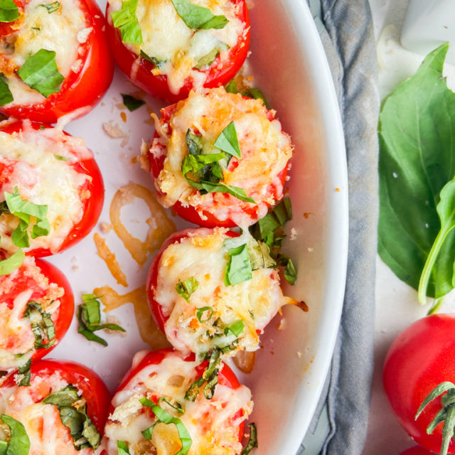 Overhead photo of baked tomatoes in a white baking dish.