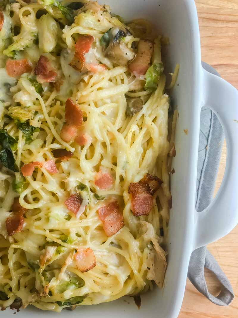 Use your leftover turkey to make this creamy Baked Turkey Spaghetti. Loaded with shredded turkey, brussels sprouts, mushrooms, bacon and cheese. 