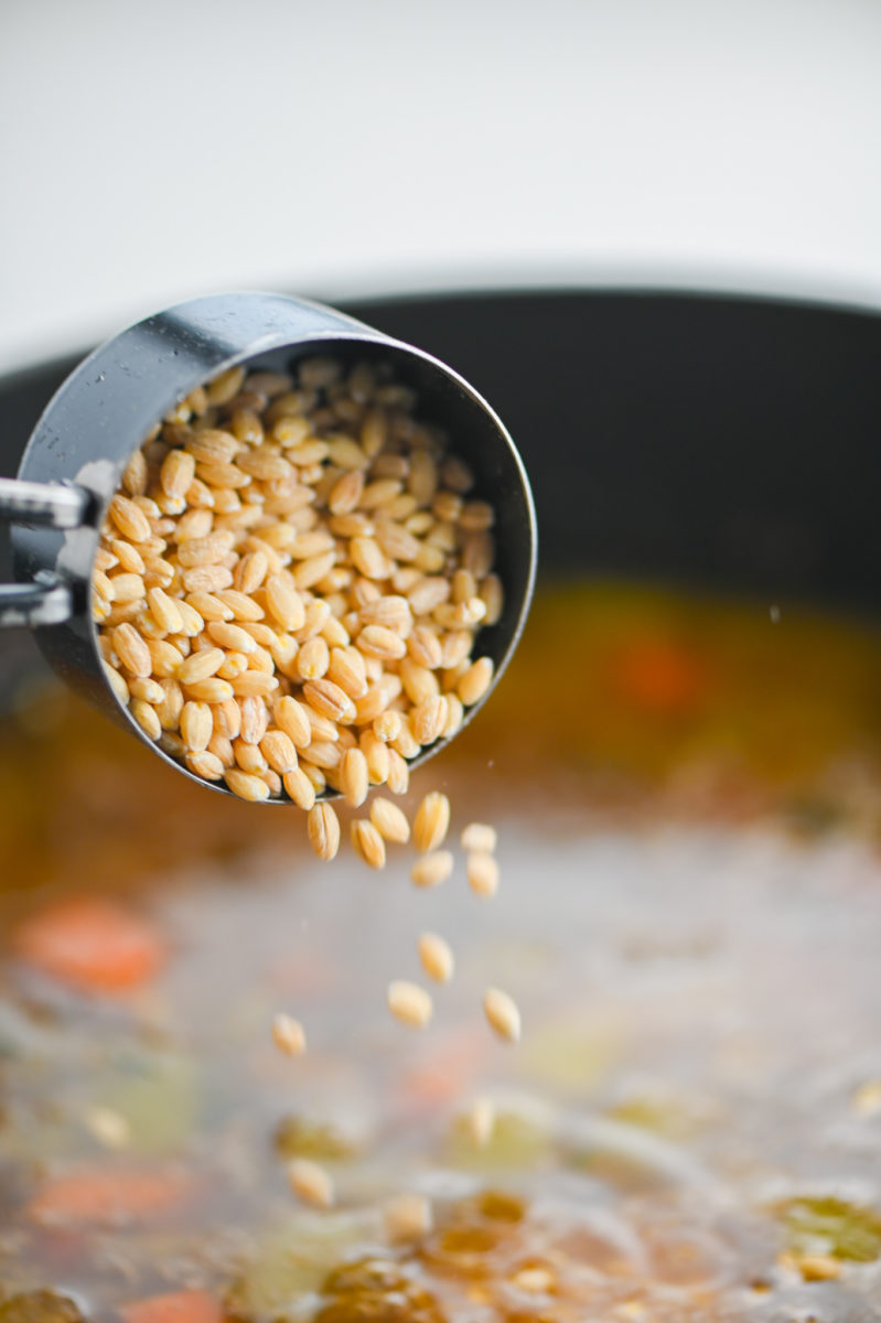 Adding barley to soup. 