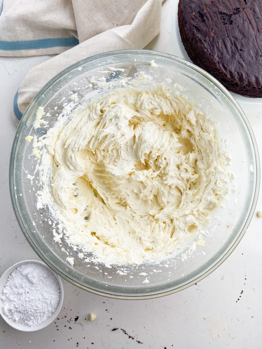 Whipped white chocolate buttercream in glass bowl.