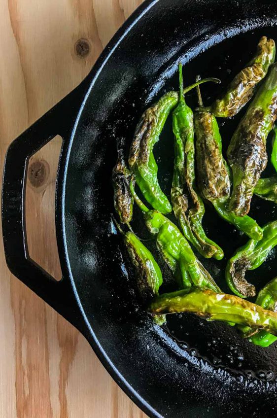 Blistered shishito peppers are pan fried until crispy and served with a sriracha cream sauce. A quick and easy appetizer for pepper lovers! 