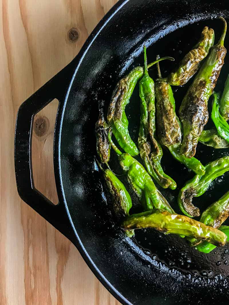 Blistered shishito peppers are pan fried until crispy and served with a sriracha cream sauce. A quick and easy appetizer for pepper lovers!