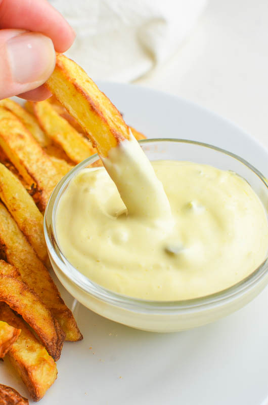 Dipping a french fry in fry sauce. 