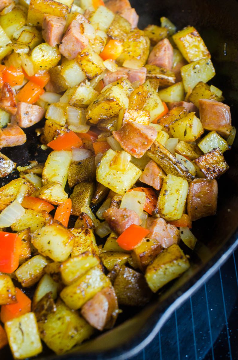 Cajun Breakfast Skillet is loaded with potatoes, andouille sausage, onions, bell peppers and cajun seasoning. Then topped with a perfectly fried egg. It's an easy, hearty way to start your day! 