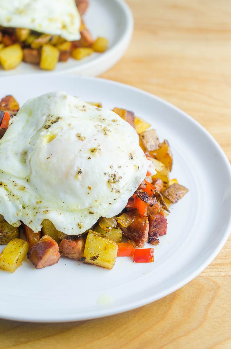 Cajun Breakfast Skillet is loaded with potatoes, andouille sausage, onions, bell peppers and cajun seasoning. Then topped with a perfectly fried egg. It's an easy, hearty way to start your day! 