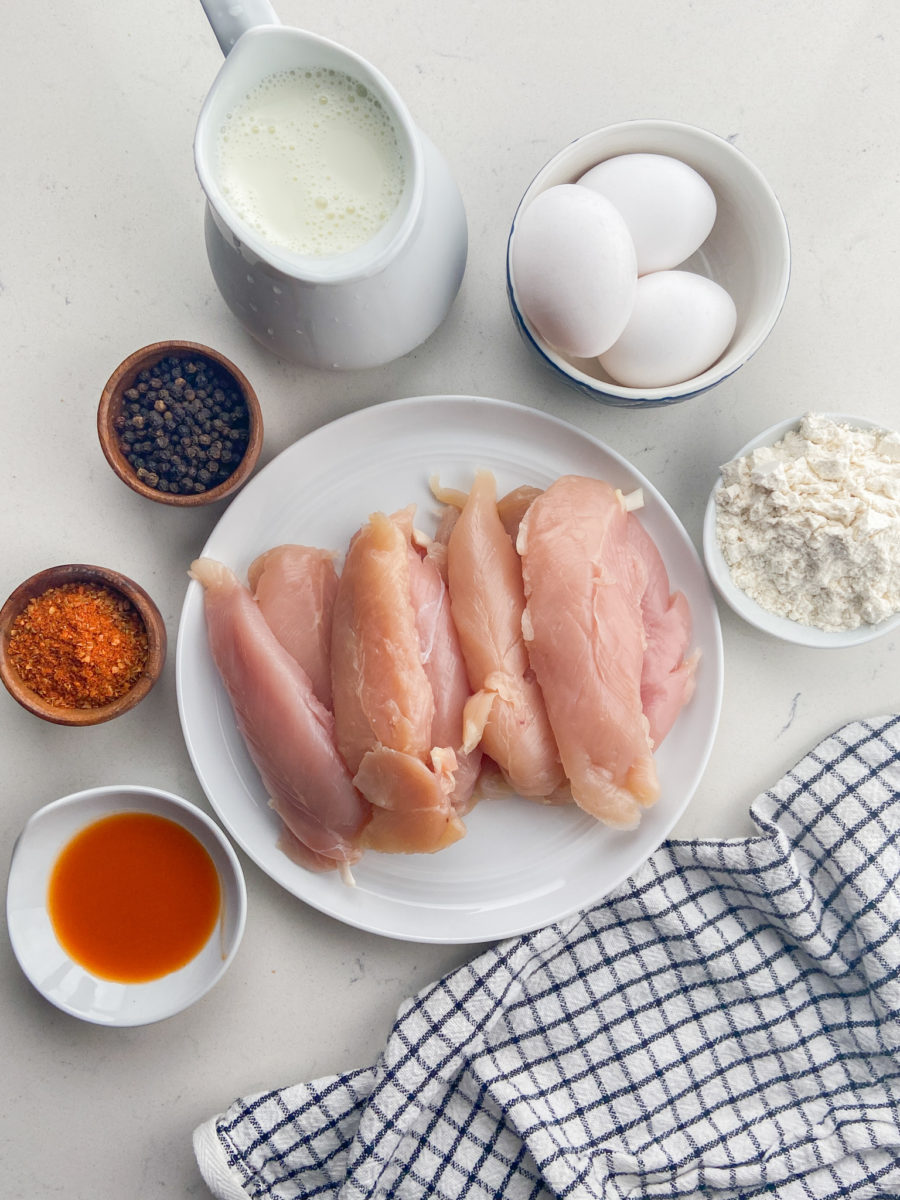 ingredients for cajun chicken tenders on white background. 