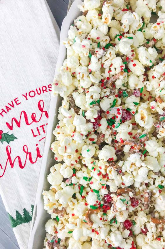 Cinnamon Christmas Popcorn with white chocolate, cinnamon candies and sprinkles will be your new favorite holiday treat. It takes about 10 minutes to prepare and makes a perfect gift too! 