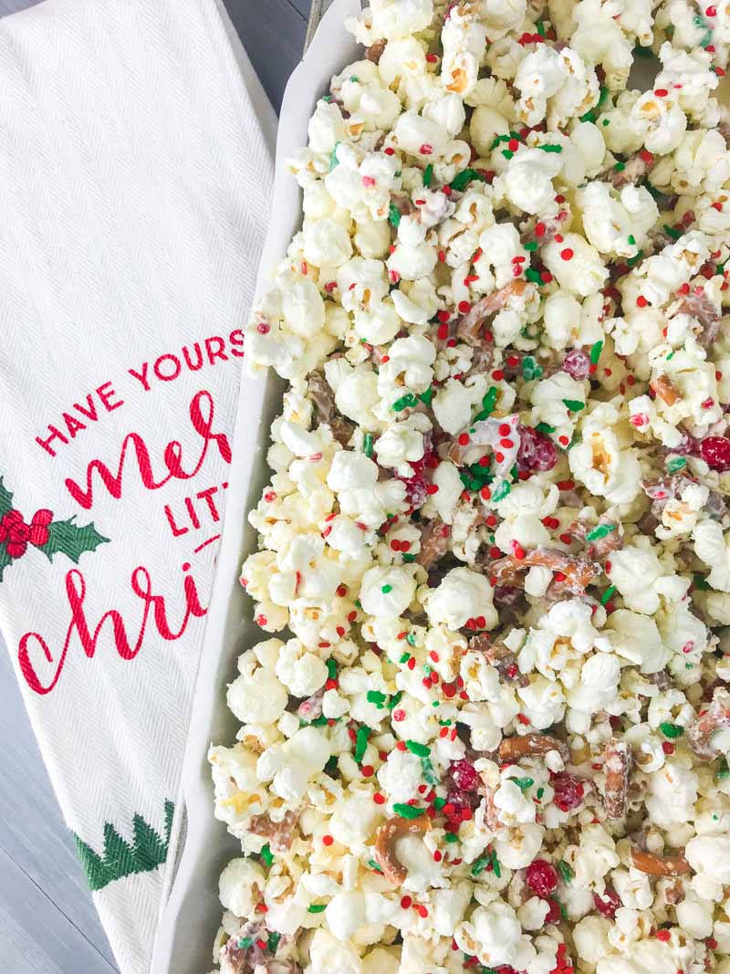 Cinnamon Christmas Popcorn with white chocolate, cinnamon candies and sprinkles will be your new favorite holiday treat. It takes about 10 minutes to prepare and makes a perfect gift too! 