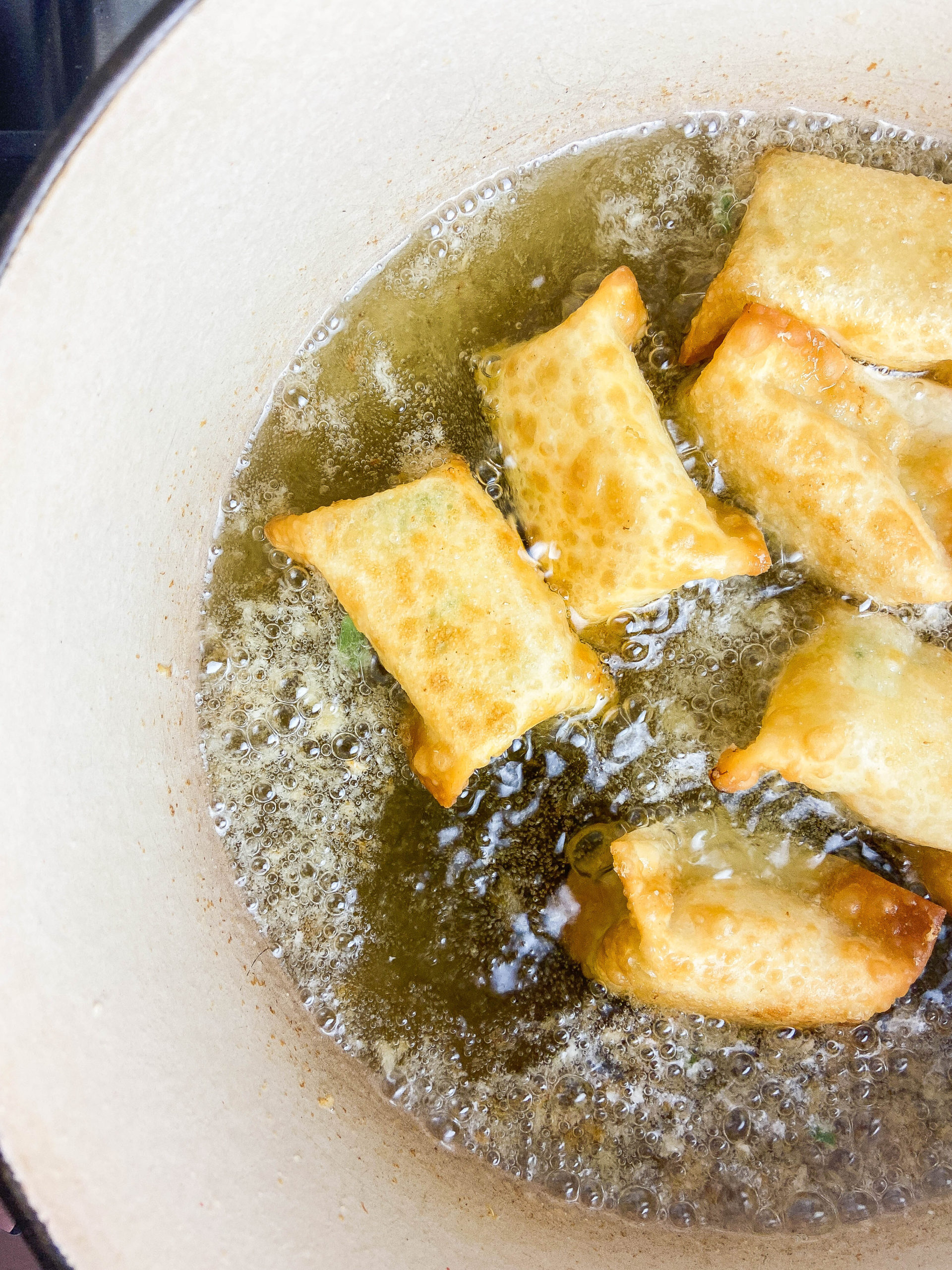 Frying wontons in oil. 