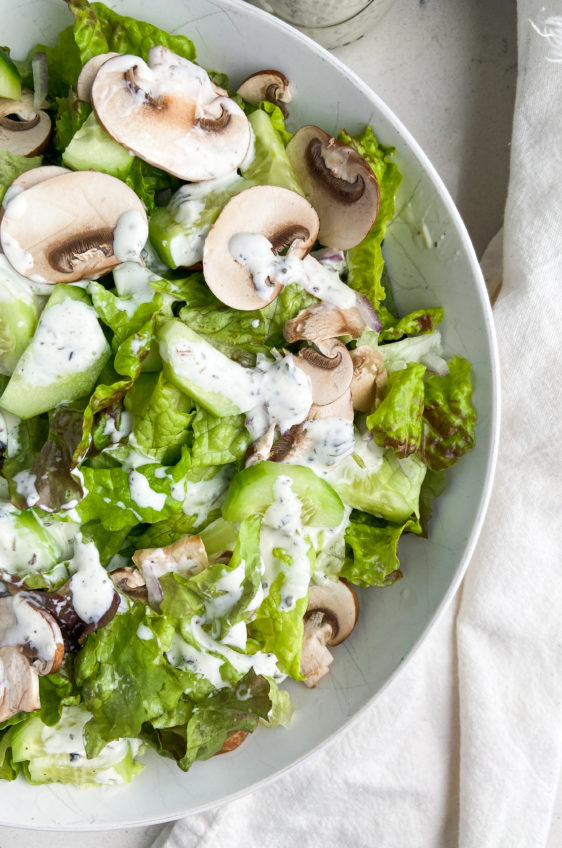 Overhead photo of salad dressed with pesto dressing.