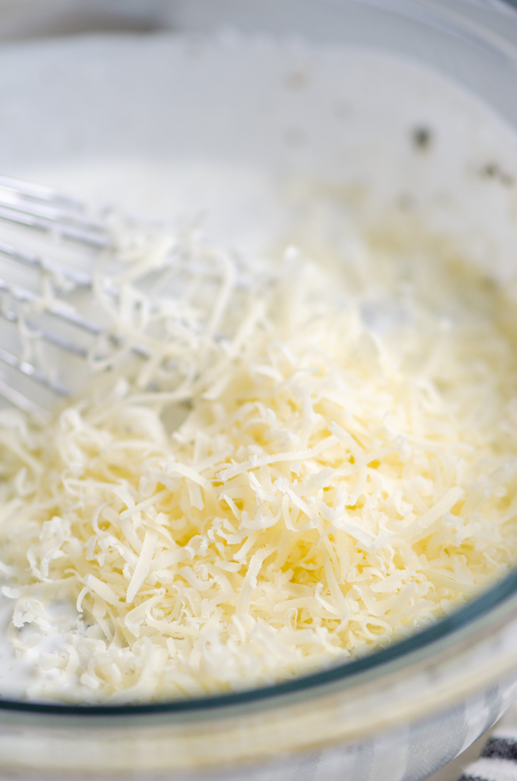Close up photo of grated parmesan in dressing