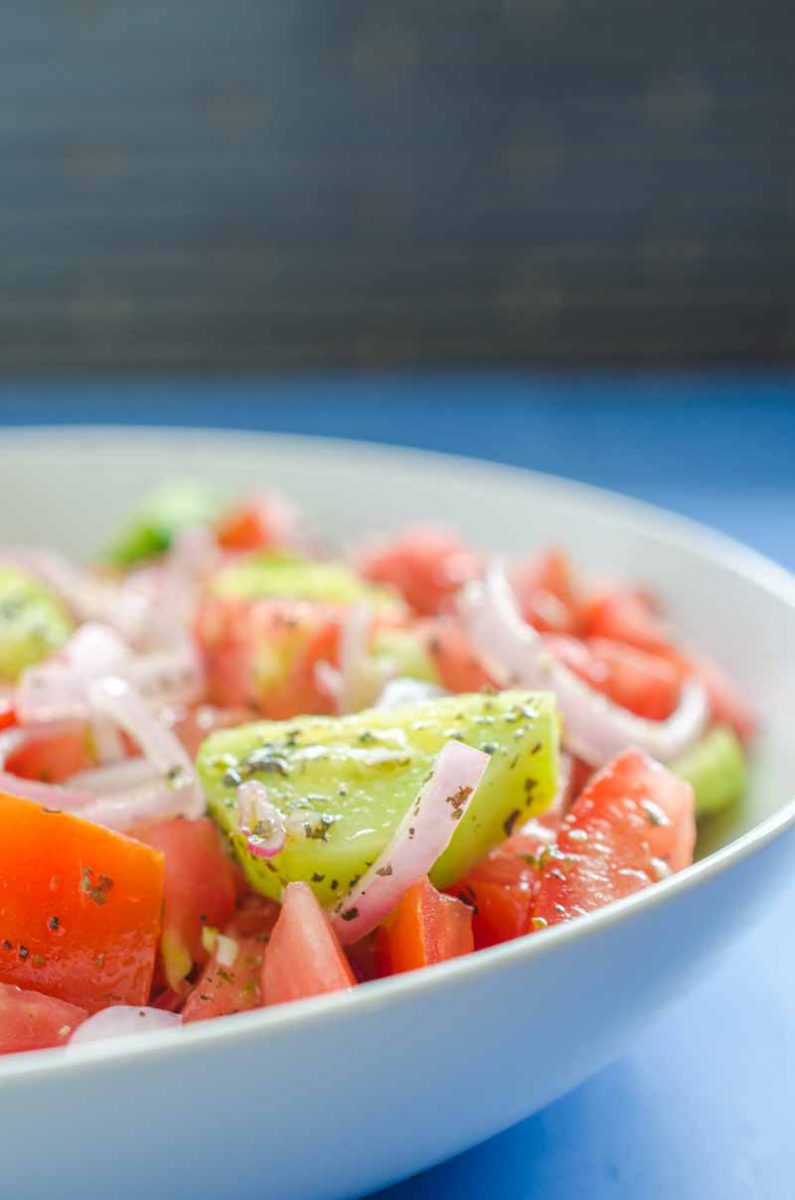 Cucumber Tomato Salad is my absolute favorite summer salad. Fresh cucumbers, summer tomatoes, shallots and a quick vinaigrette make this perfect for all of your summer cookouts. 