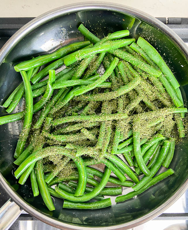 Green beans in a skillet with butter and dill. 
