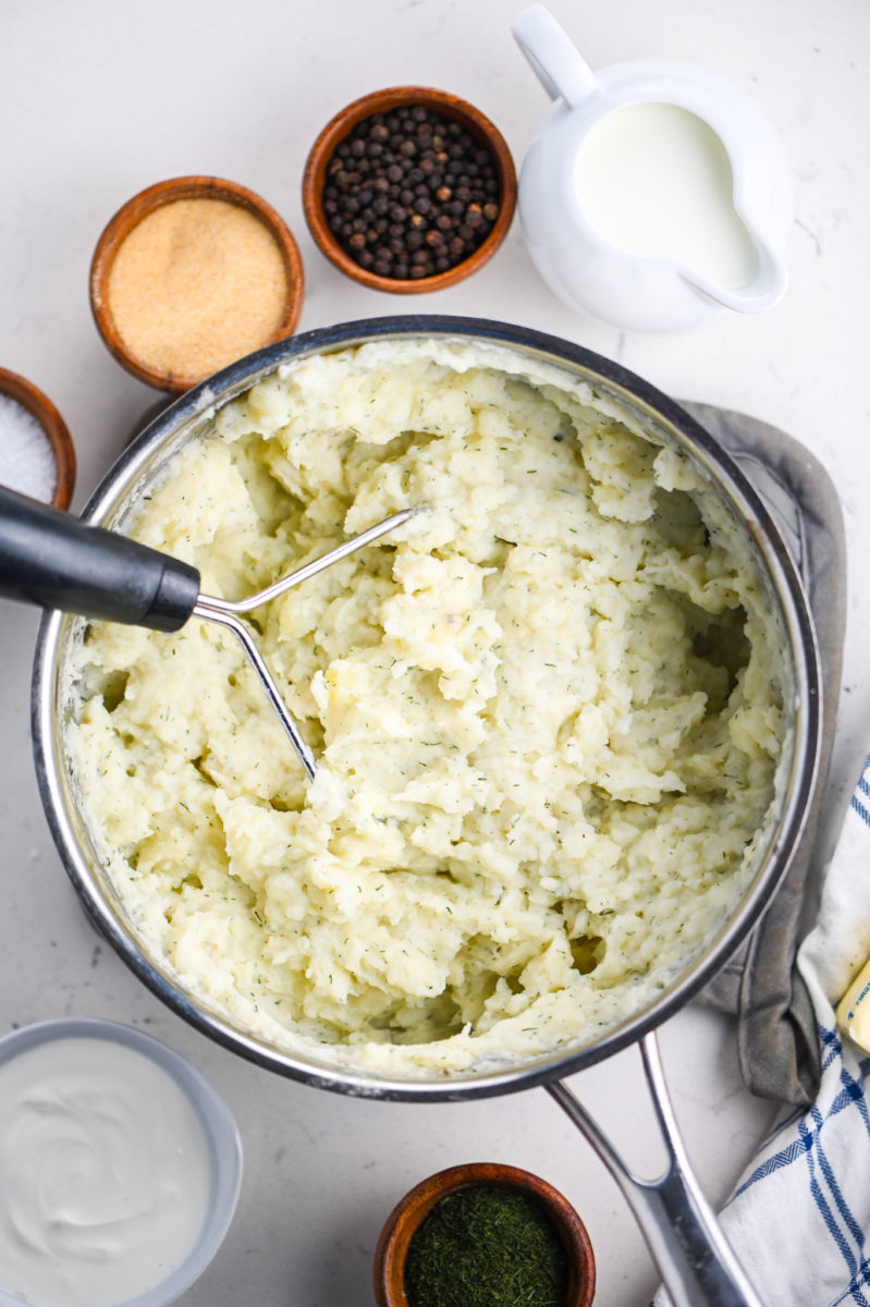 Potato masher mashing potatoes. 