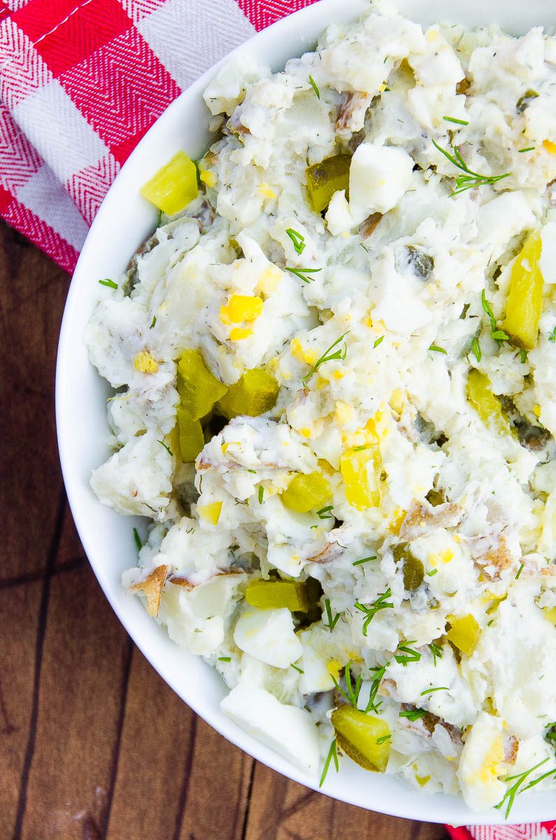 Dill Pickle Potato Salad is a lightened up potato salad made for dill pickle lovers. Greek yogurt based and loaded with potatoes, dill pickle brine, chopped dill pickles, dill relish and fresh dill. 