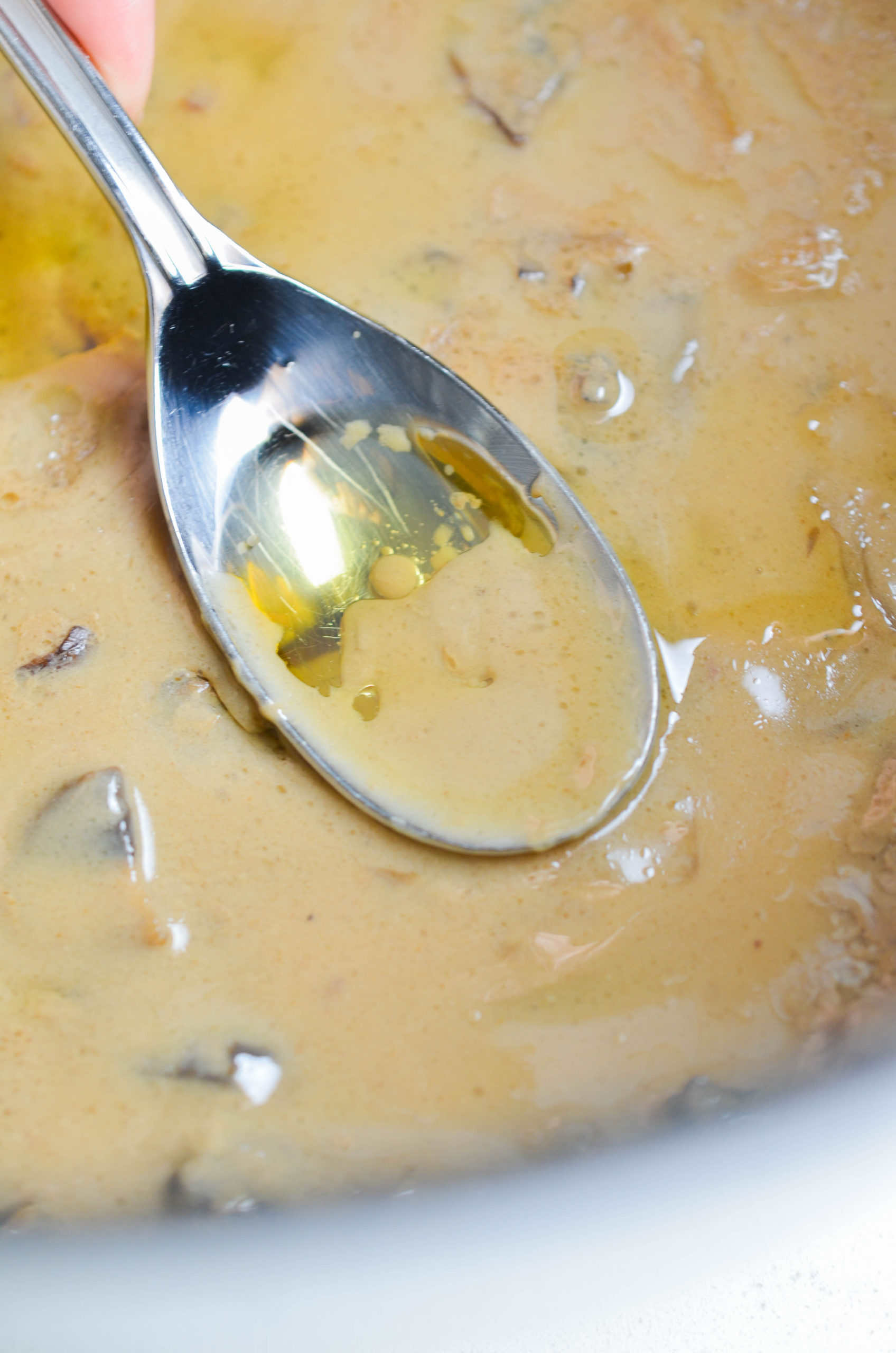 Remove the top layer of fat from the gravy with a spoon. 