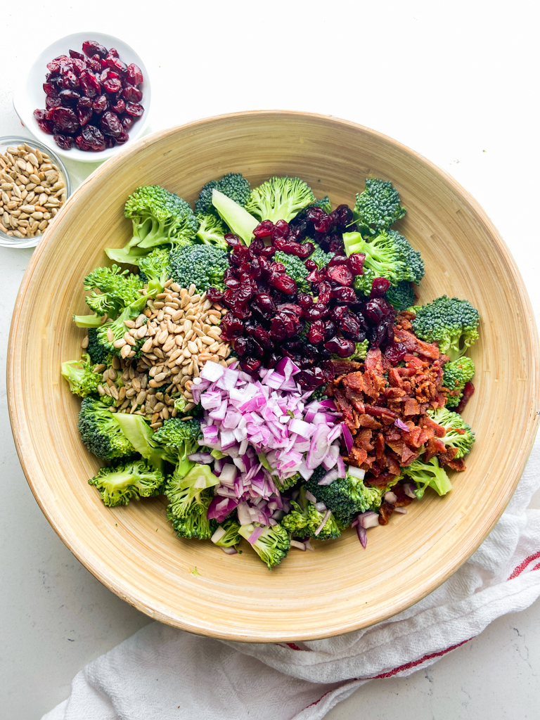 Broccoli salad ingredients in a wooden bowl. 