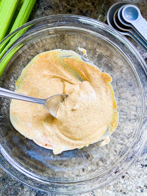 Macaroni salad dressing in a glass bowl. 