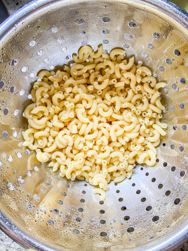 cooked elbow macaroni in a colander. 