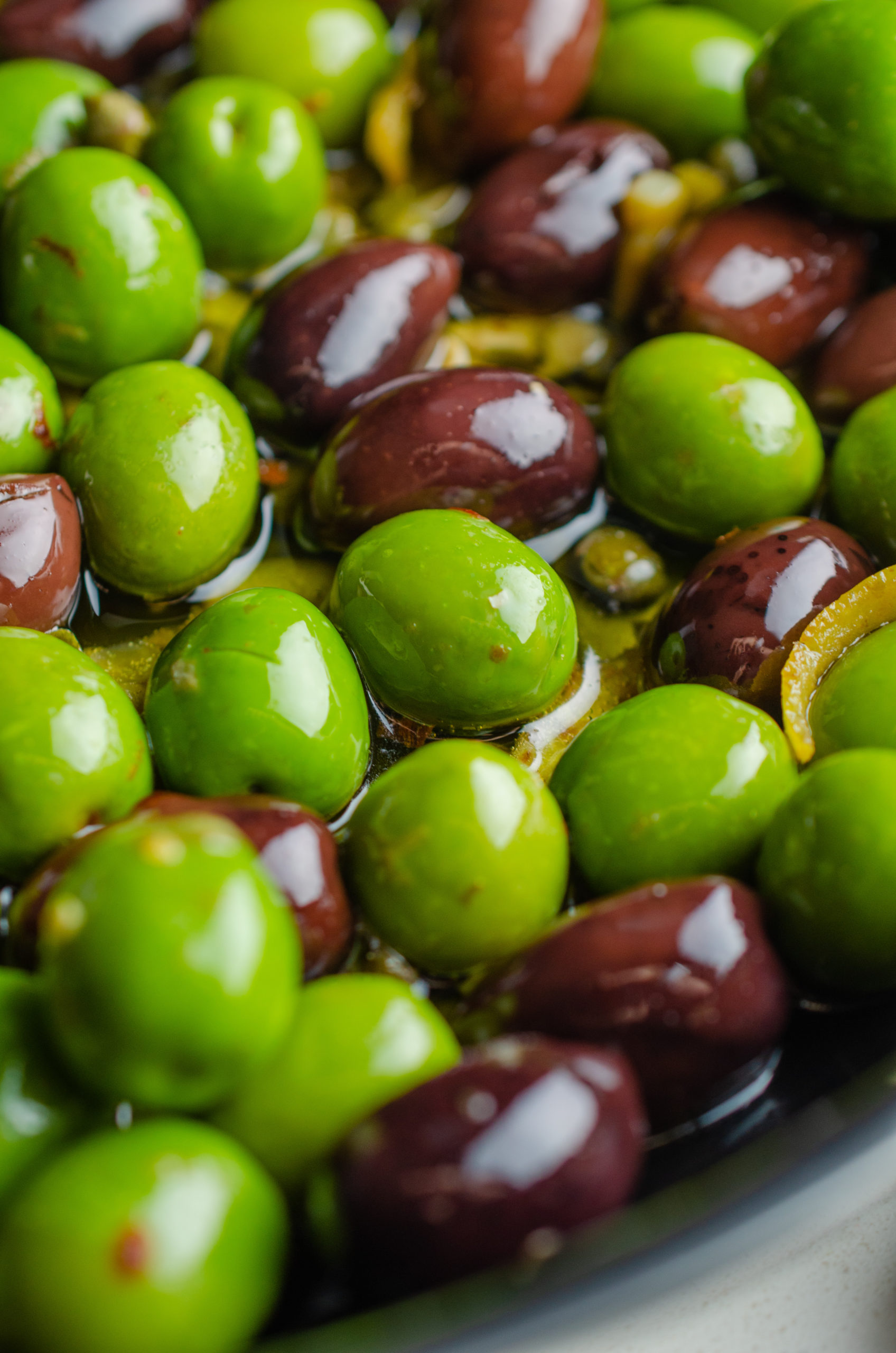 Cooking olives in oil in a pan. 