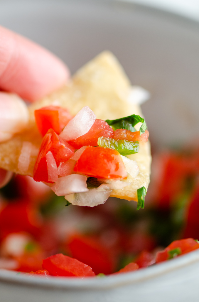 Close up of chip with pico de gallo on it. 