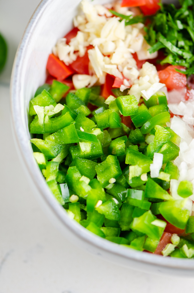 Side close up photo of diced jalapenos. 