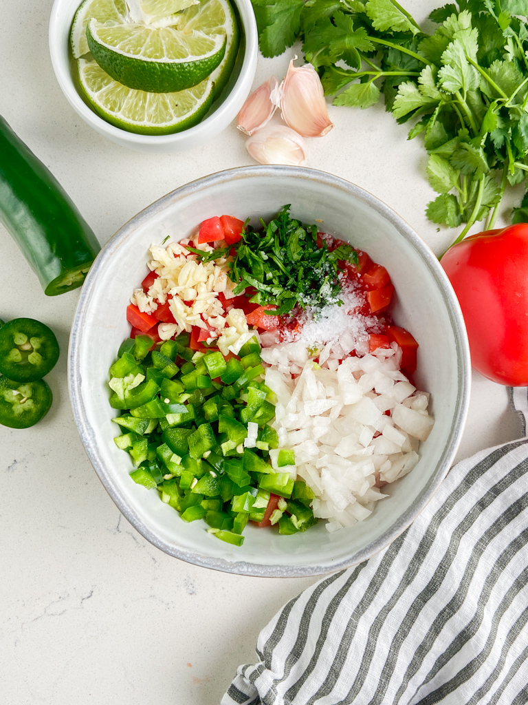 Overhead photo of pico de gallo in a clay bowl. 