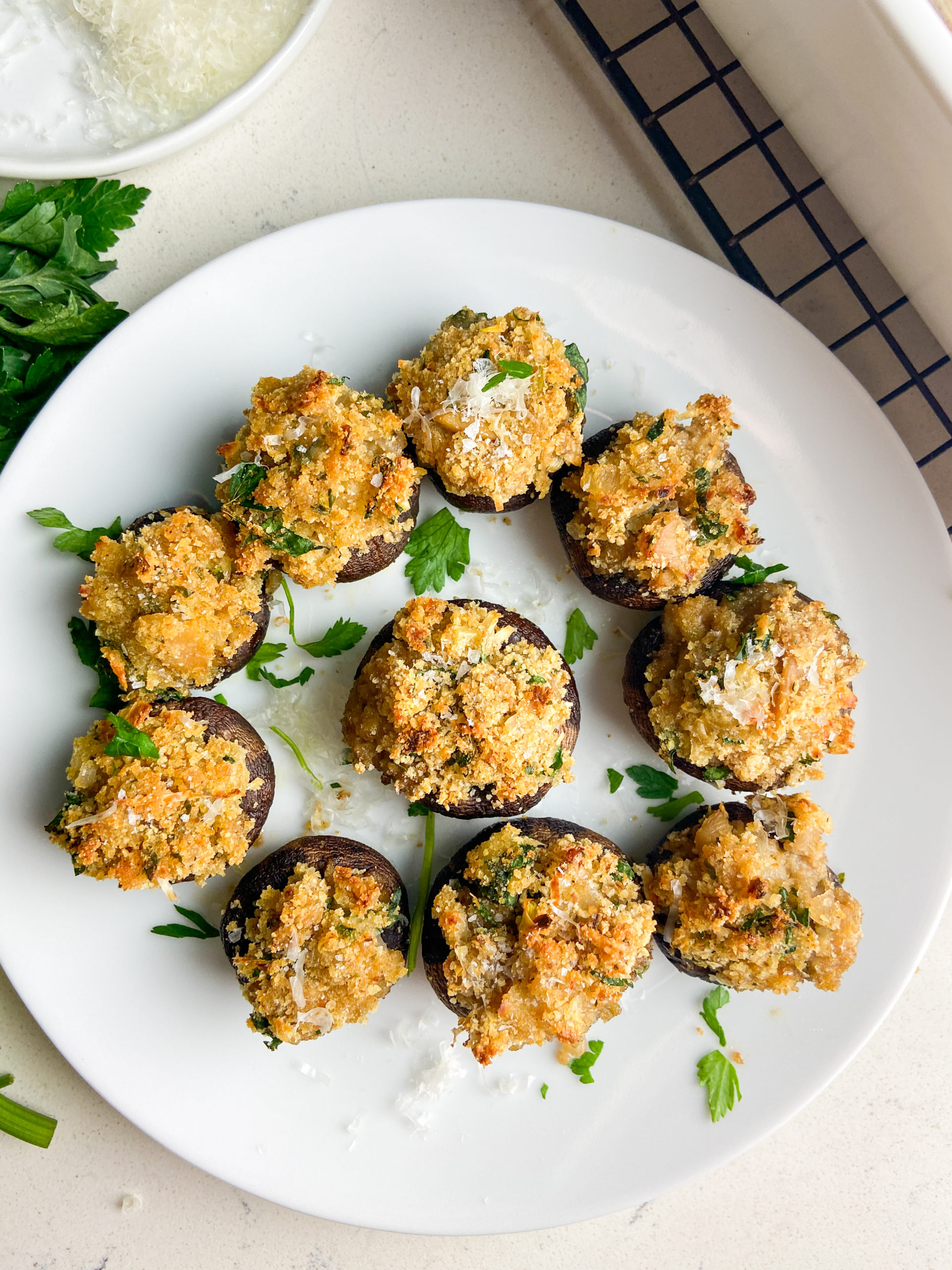 overhead photo. of stuffed mushrooms on white plate