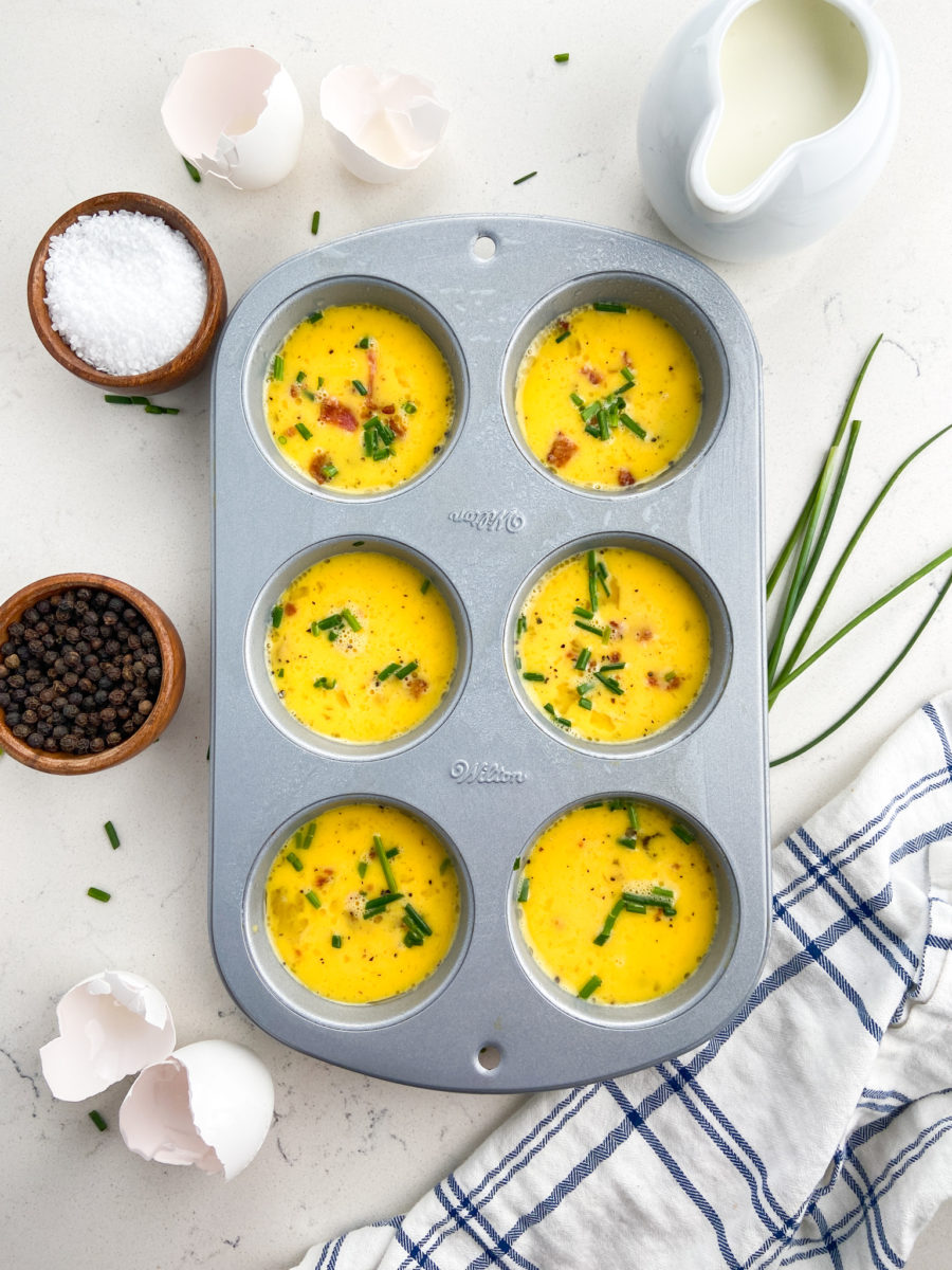 Uncooked egg bites in muffin tin. 