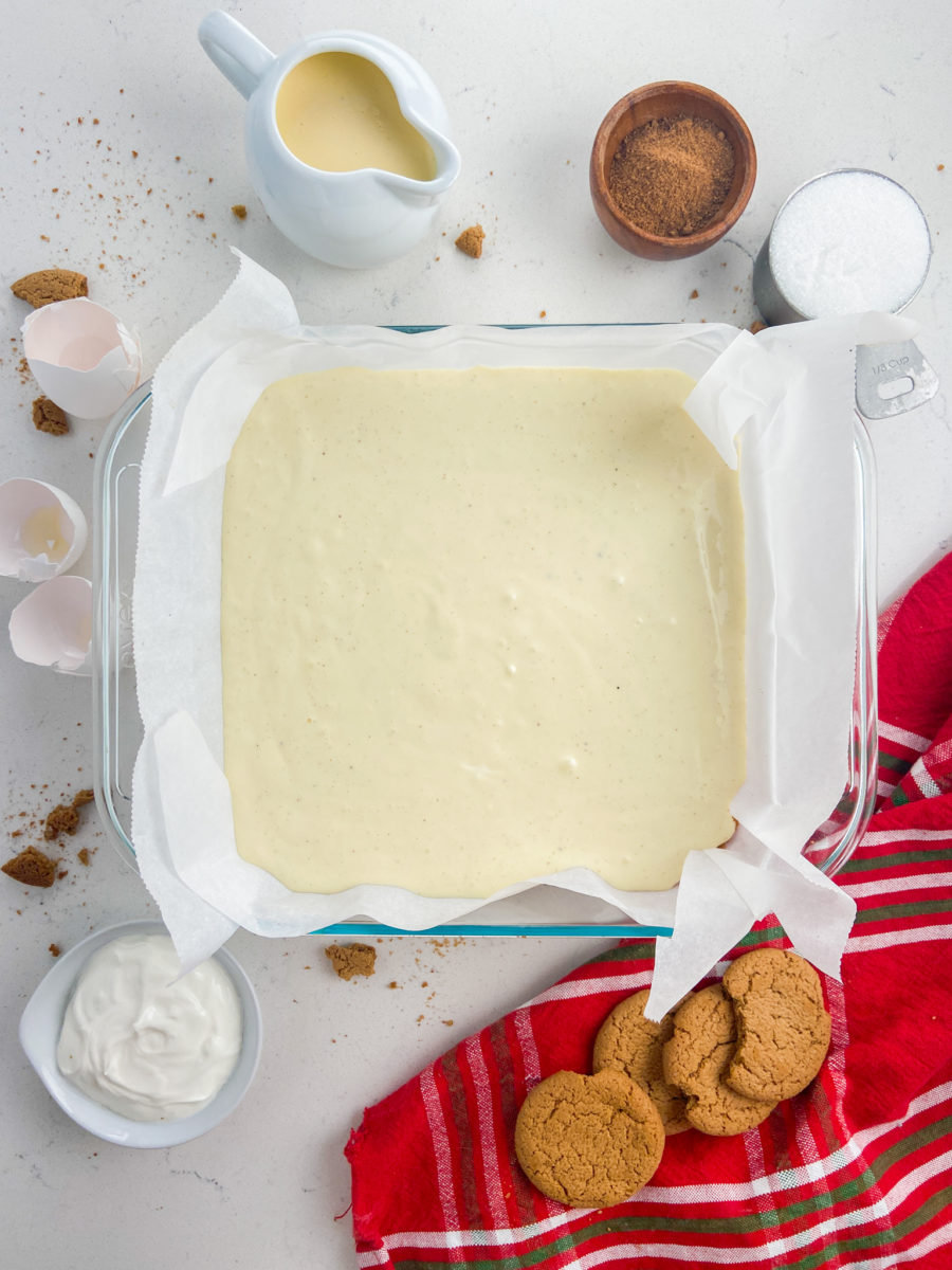 Unbaked cheesecake bars in baking dish. 