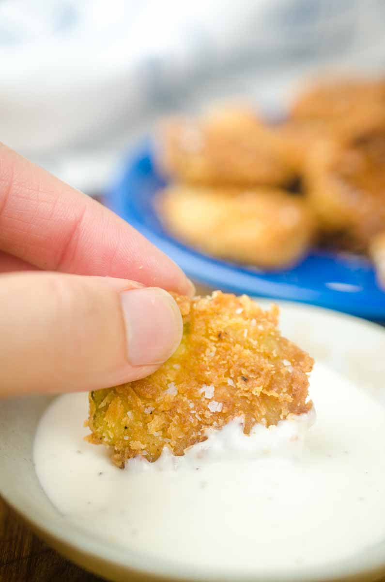 Dipping pickle in ranch dressing. 