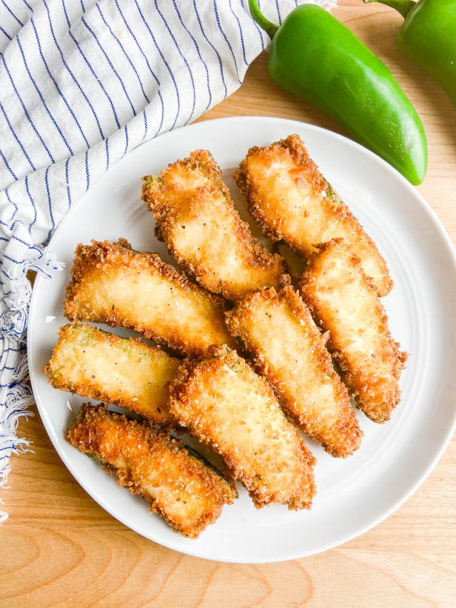 Overhead photo of jalapeno poppers on a white plate. 