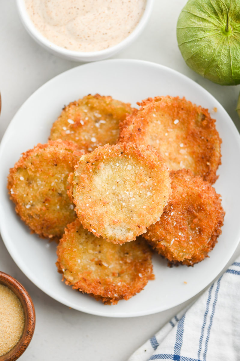 Fried Tomatillos on a white plate. 