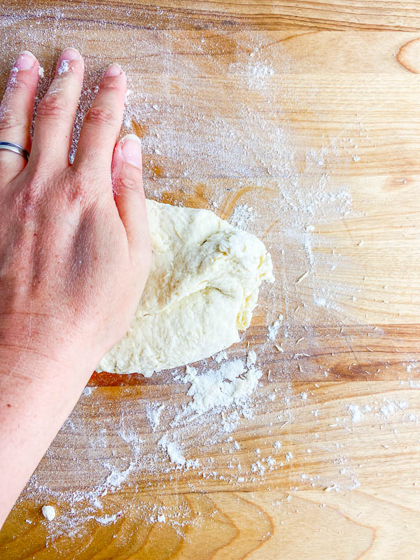 Kneading down on a lightly floured surface. 