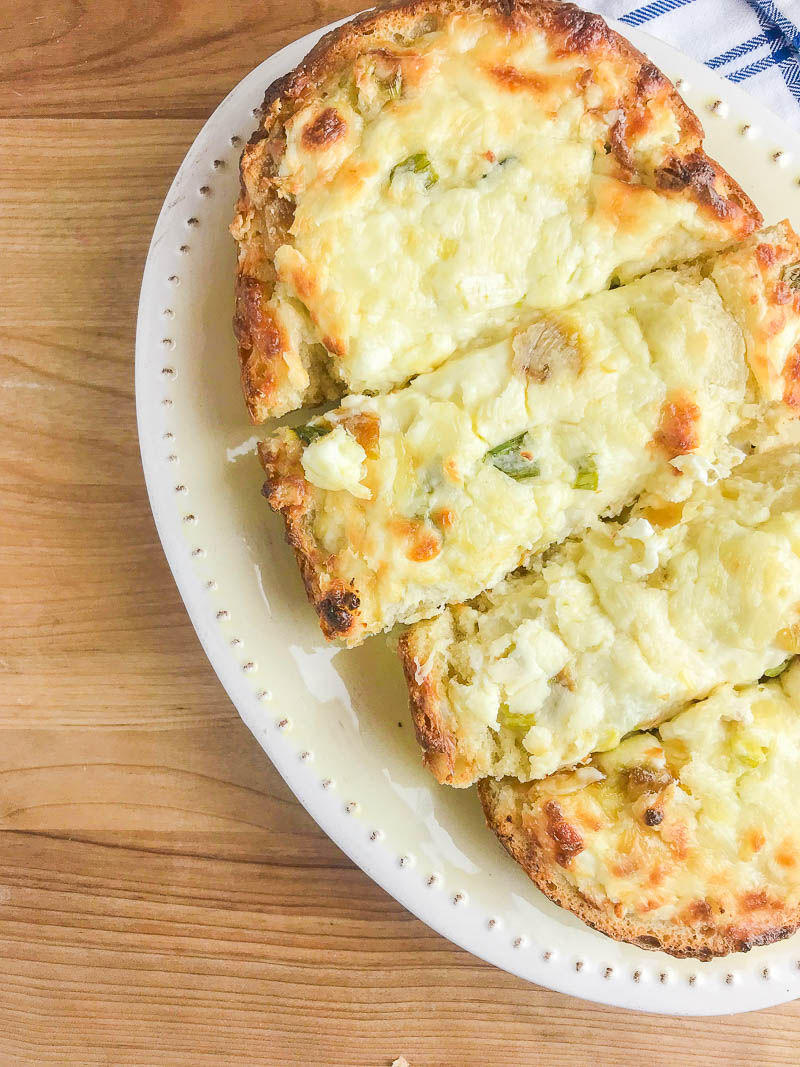 Garlic Cheese Bread with 3 cheeses and sweet roasted garlic. An easy, cheesy bread that is a perfect side dish or a meal in itself!