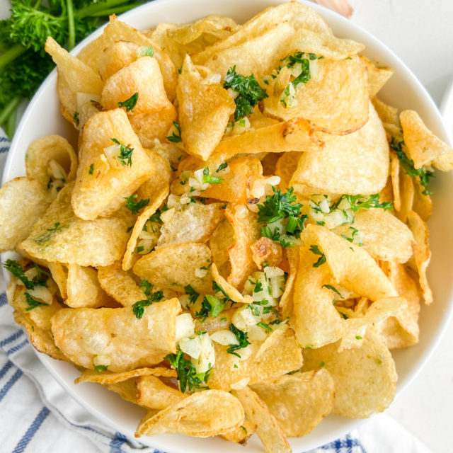 Overhead photo of garlic chips in white bowl.