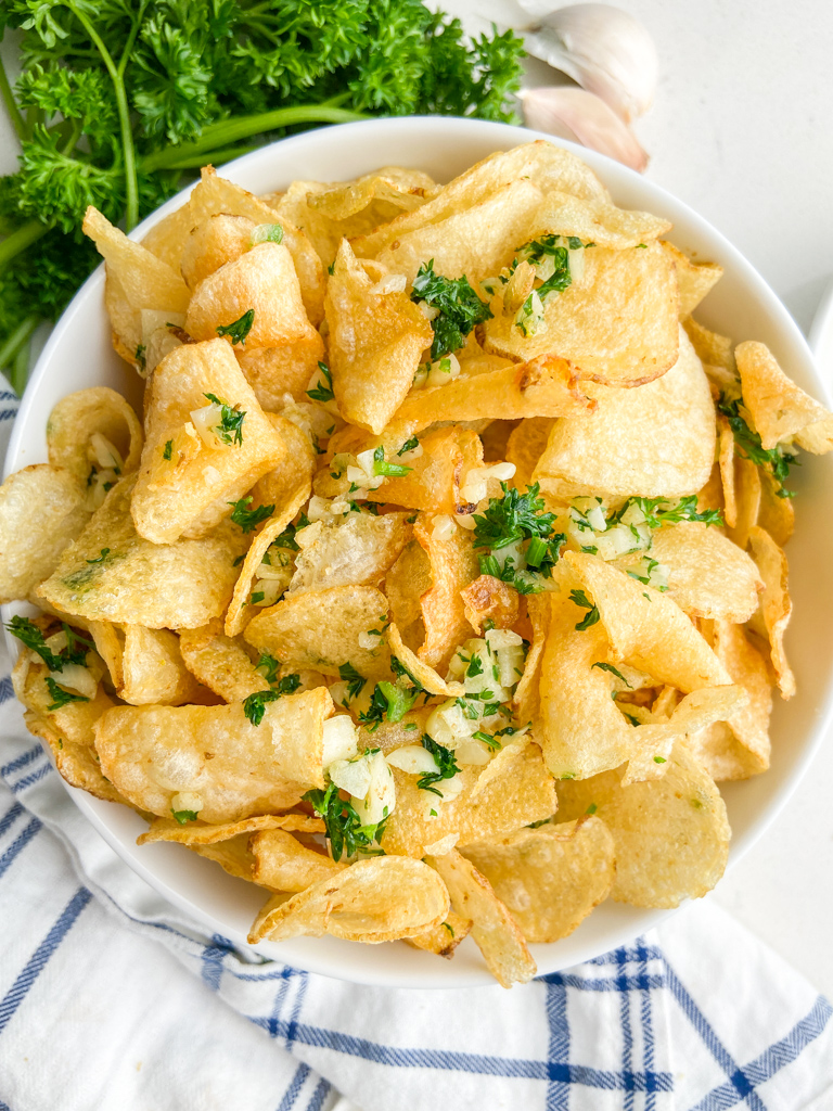 Overhead photo of garlic chips in white bowl.