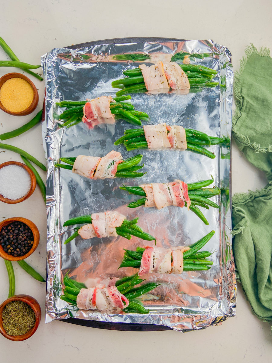 Green bean bundles on baking sheet. 