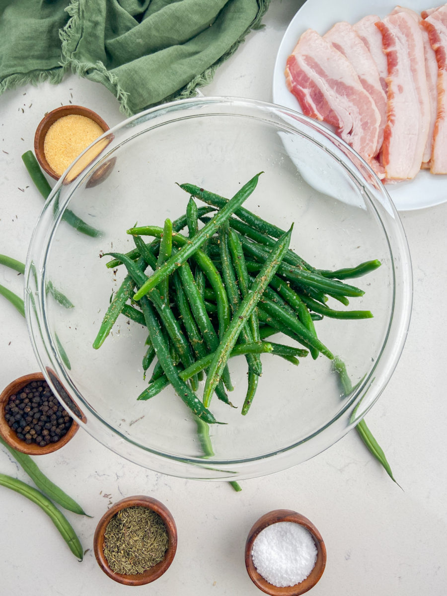 Seasoned green beans in glass bowl. 