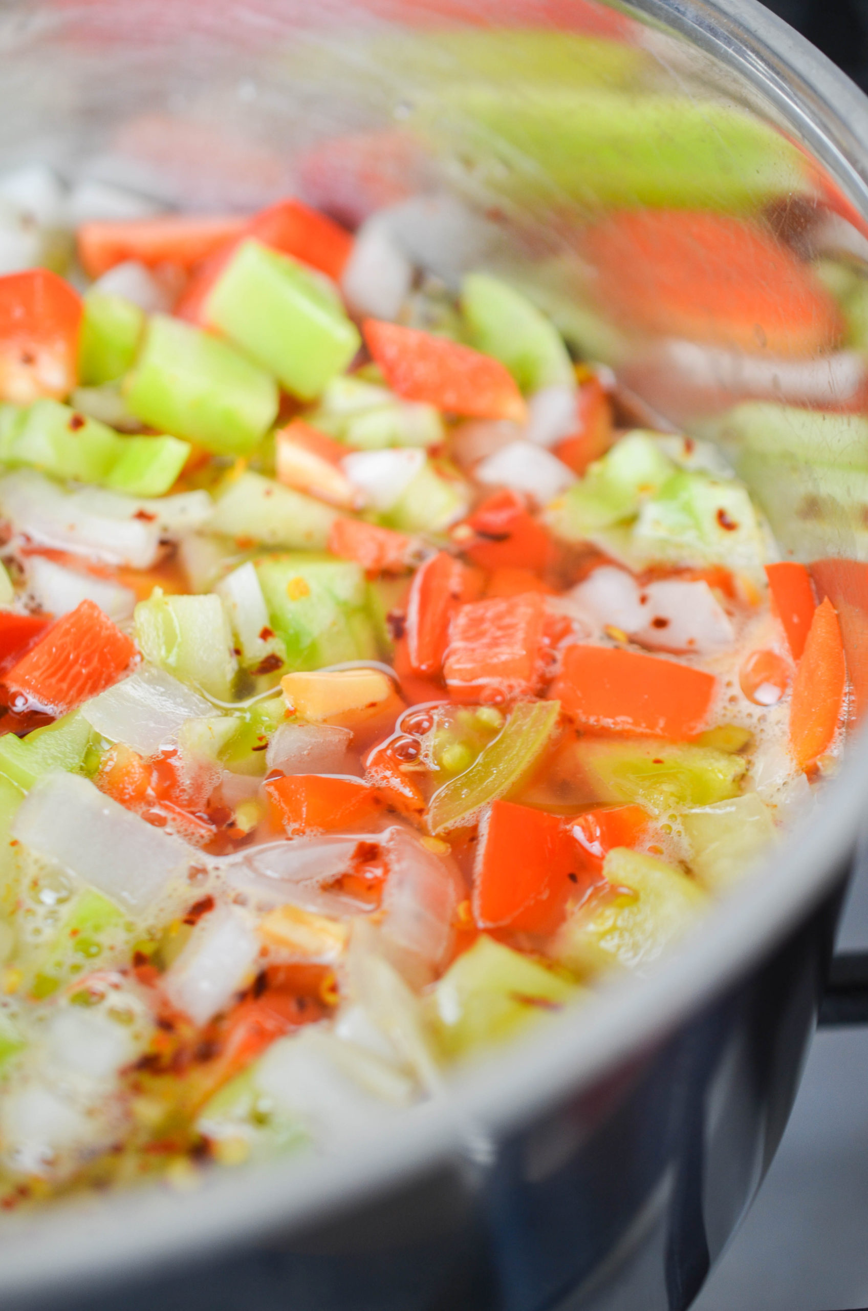 Green tomato relish simmering in a saucepan. 