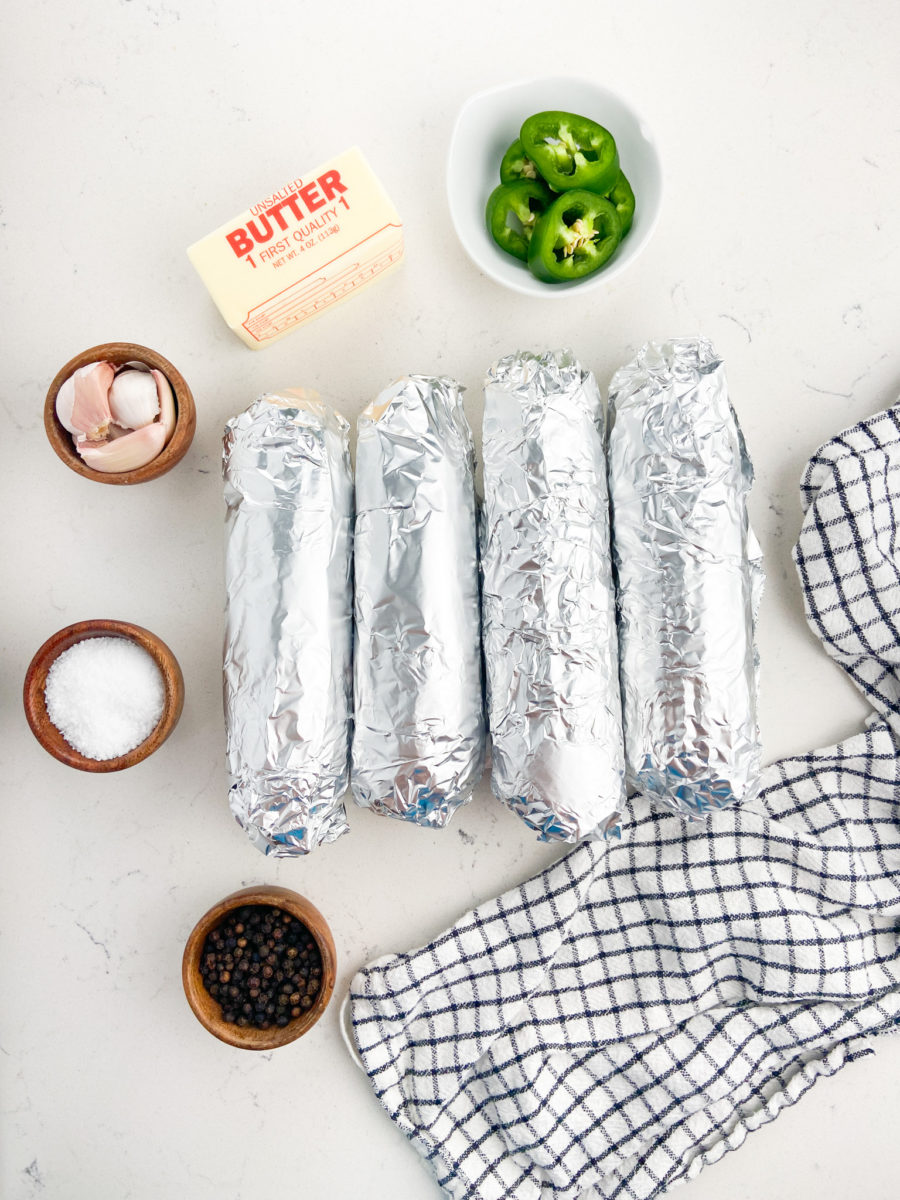 Corn cobs wrapped in aluminum foil. 