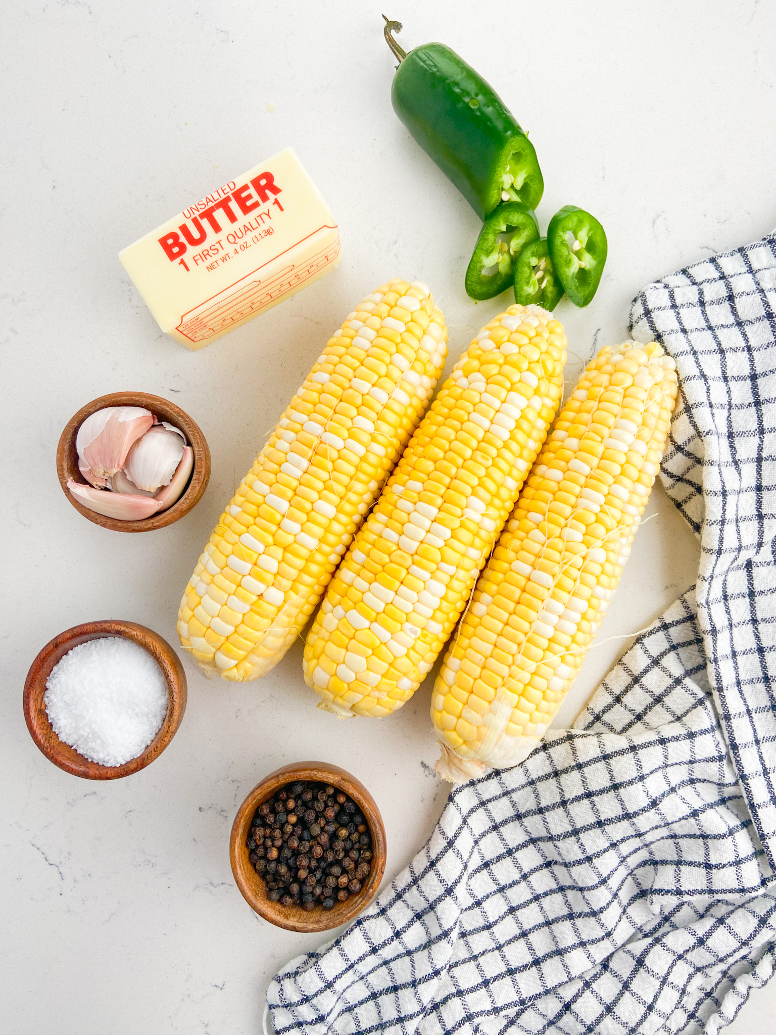 Grilled corn with jalapeño butter ingredients. 