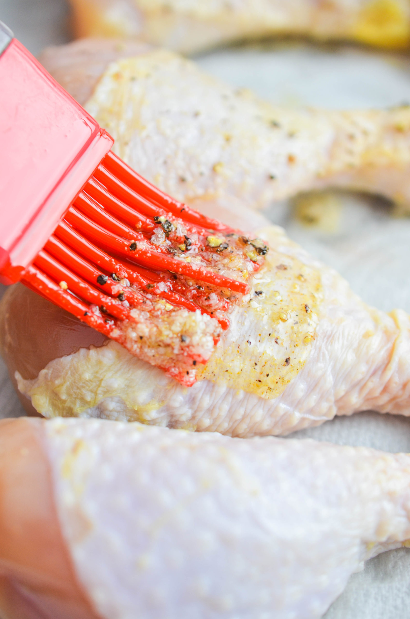 Brushing garlic oil over chicken. 