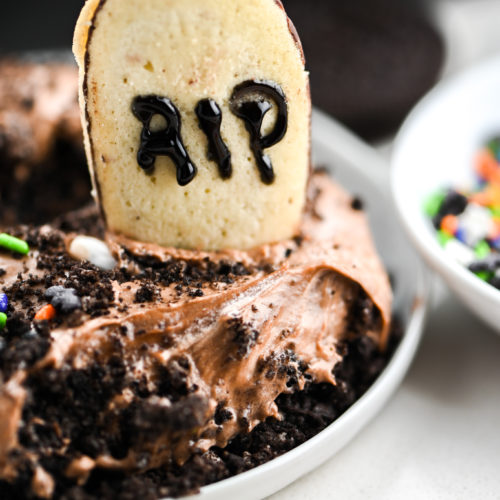 Scoop of Halloween dirt pudding on white plate.