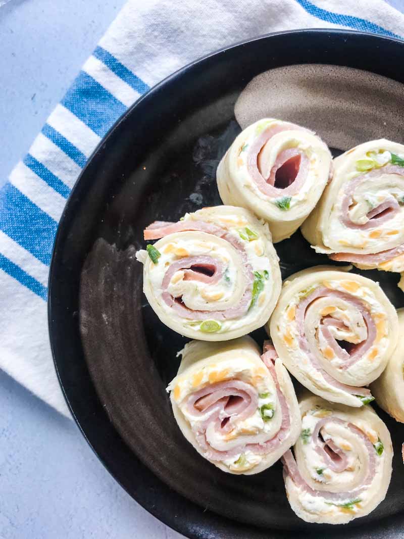 Easy Ham Roll Ups are a quick and easy appetizer that is perfect for tailgating, parties and even the kiddos lunches!