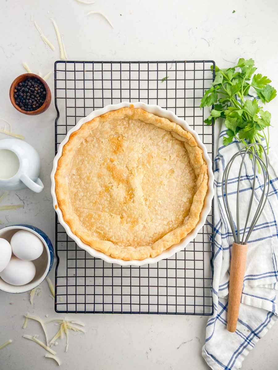 Empty blind baked pie crust on cooling rack. 