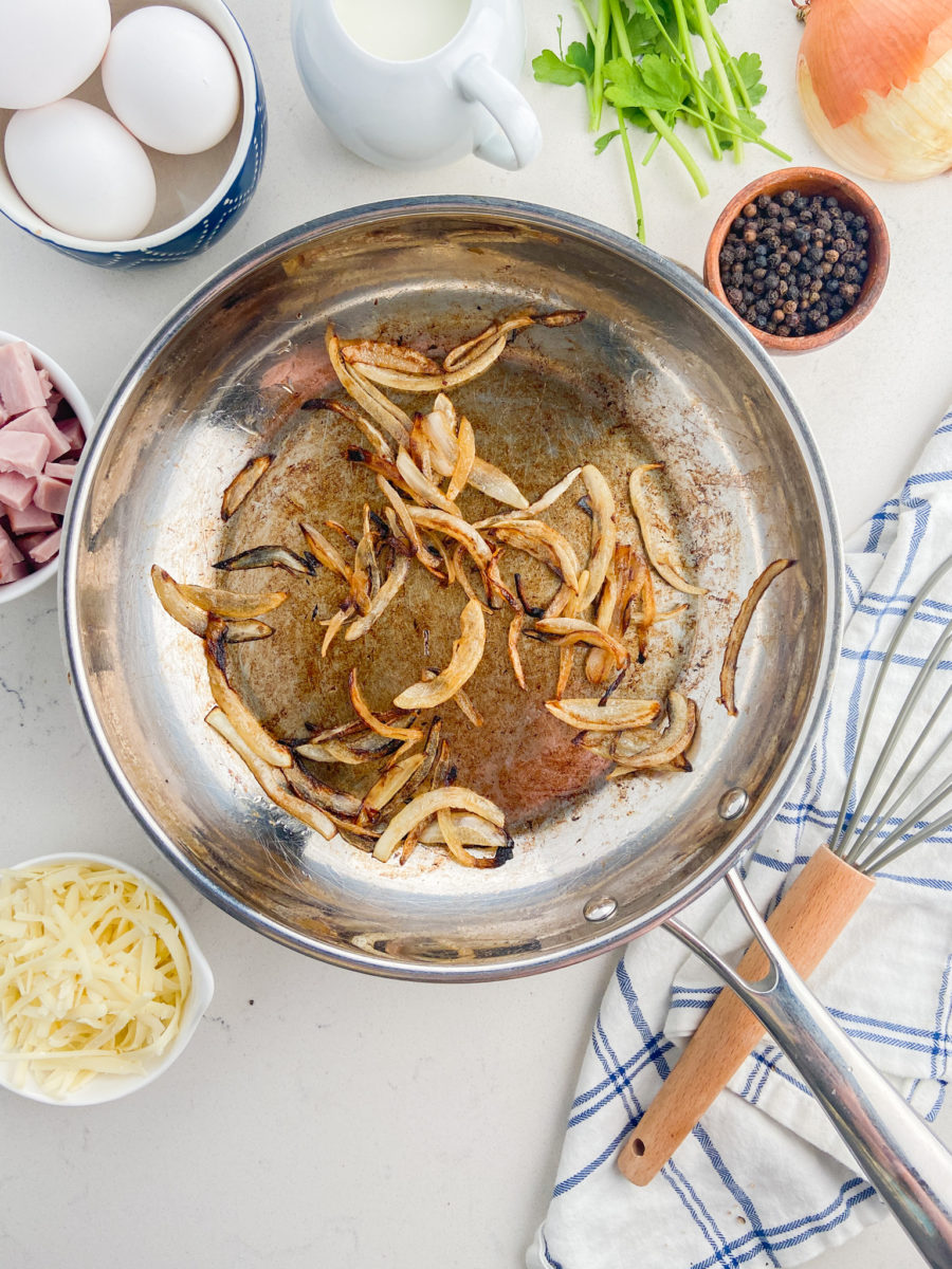 Sautéed onions in stainless steel pan. 