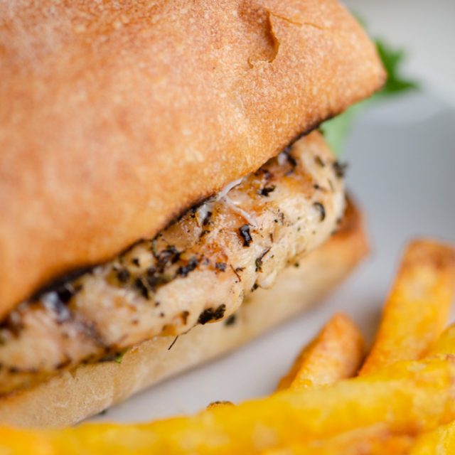 Close up side photo of chicken sandwich.