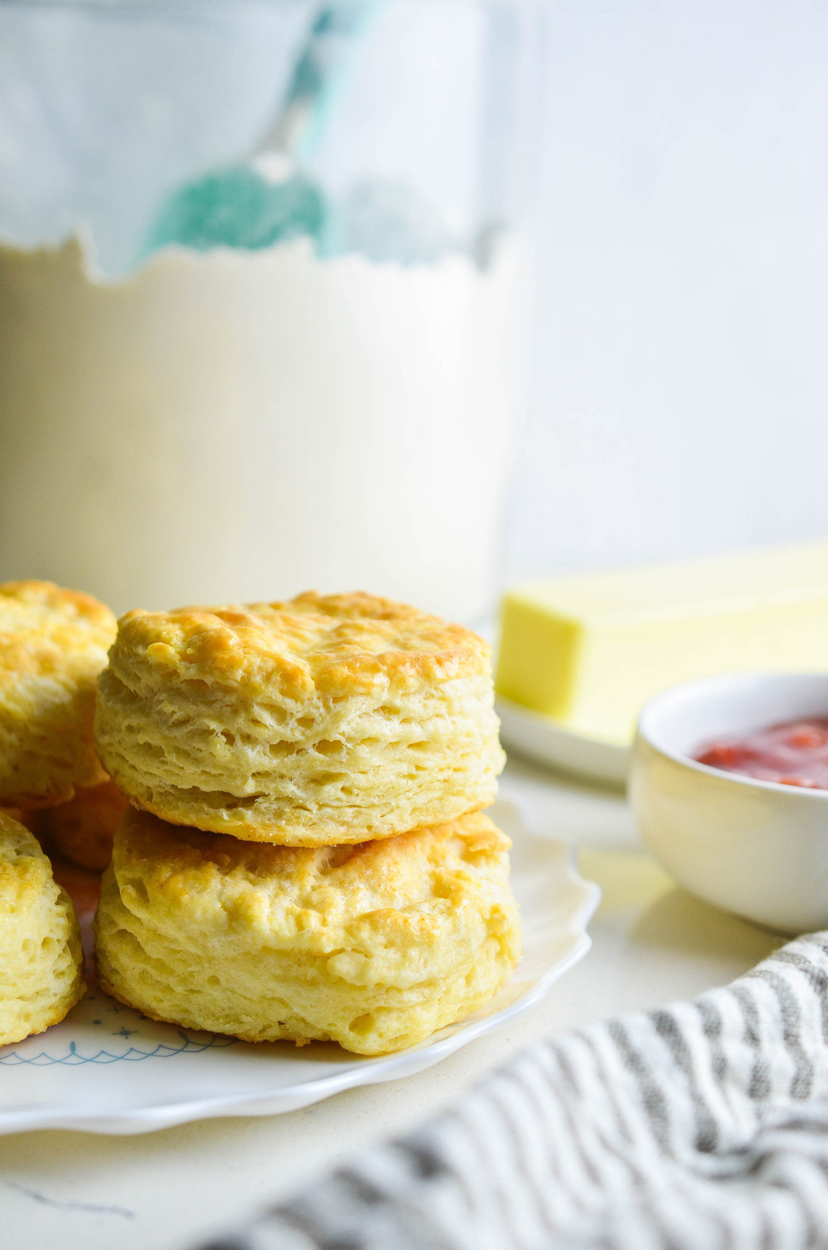 Two buttermilk biscuits staked on top of each other. 