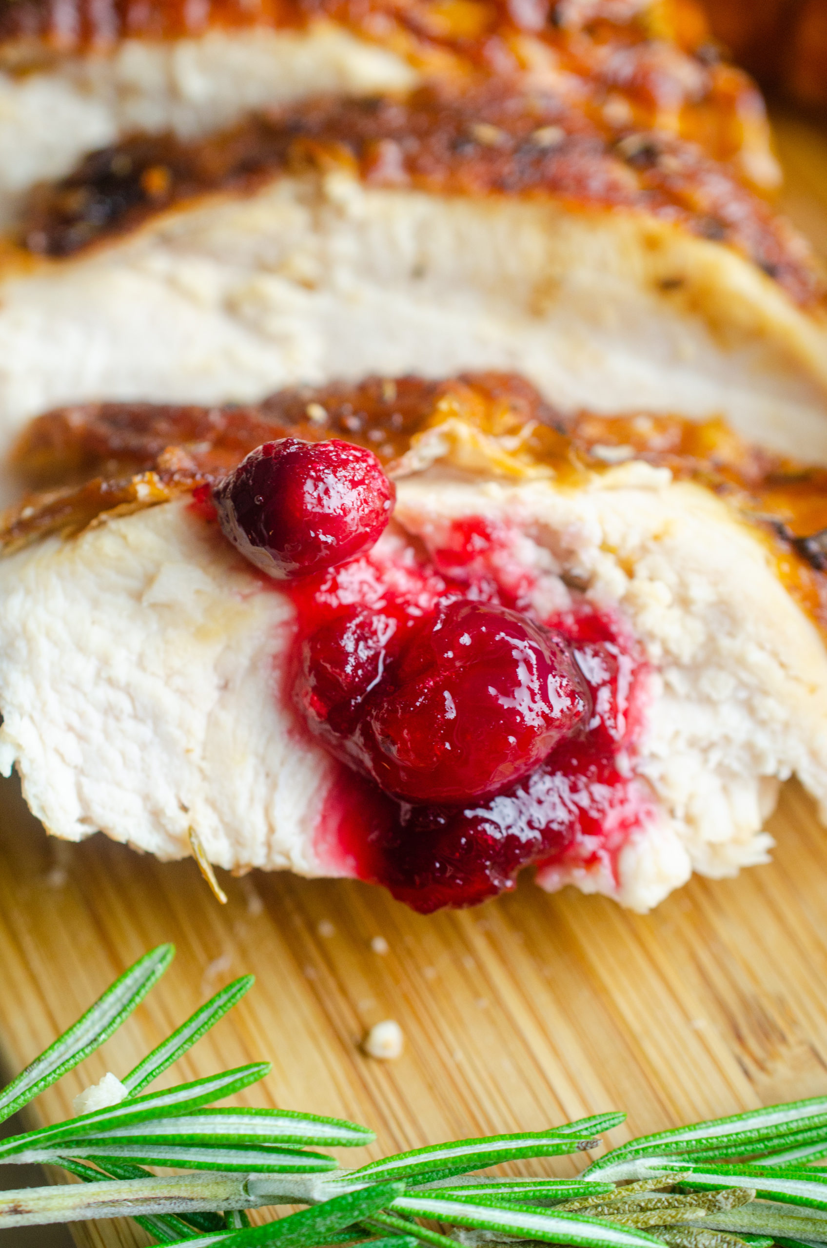 A spoonful of cranberry sauce on a slice of turkey. 